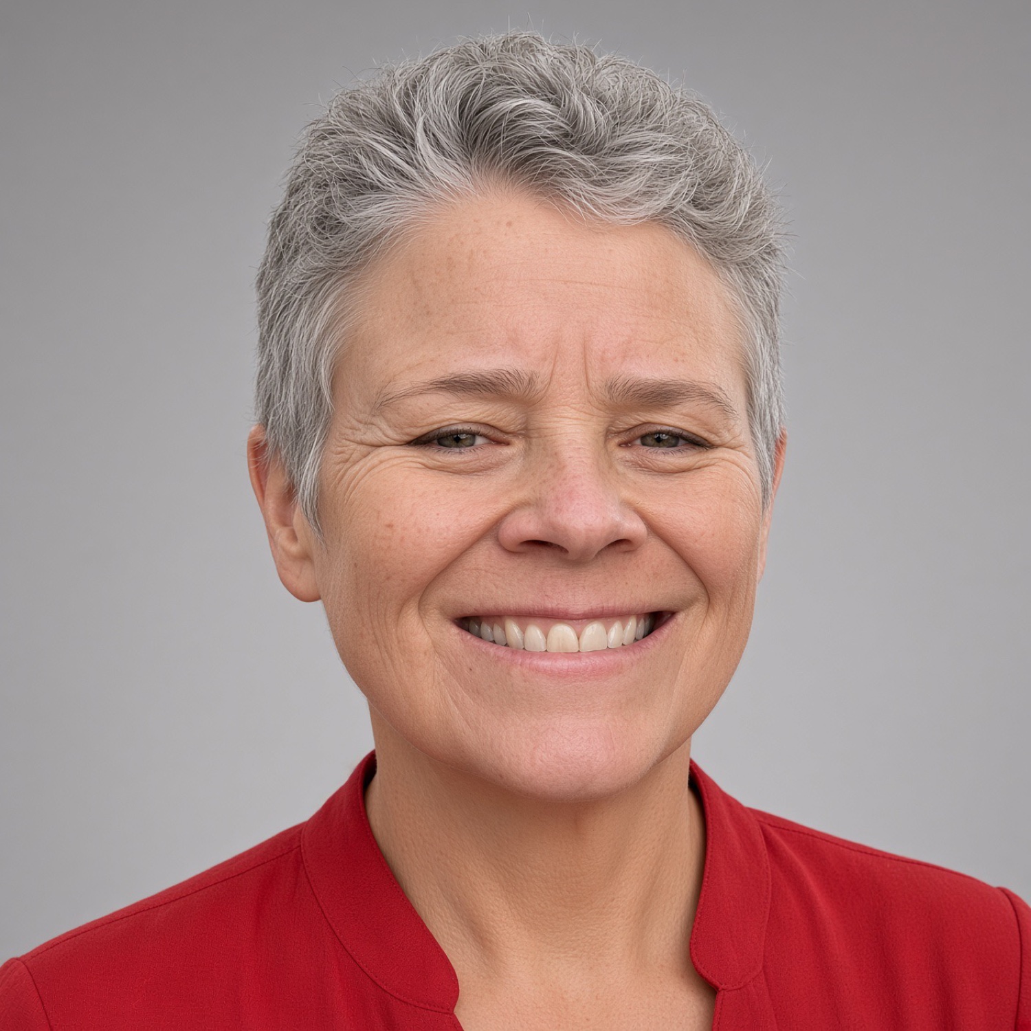 Christine Mackey smiling in a red top
